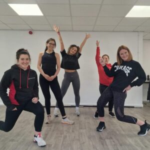 An image of a personal trainer and her students